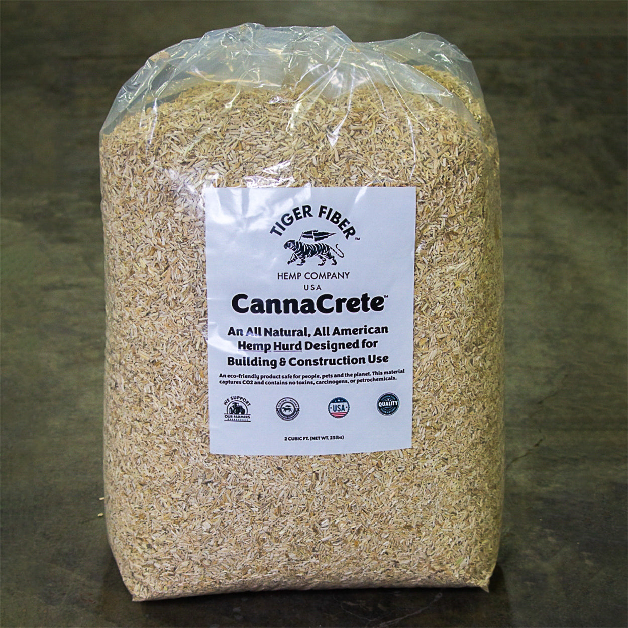 A 25 pound translucent packaged bag of hemp CannaCrete standing erect off industrial floor.
